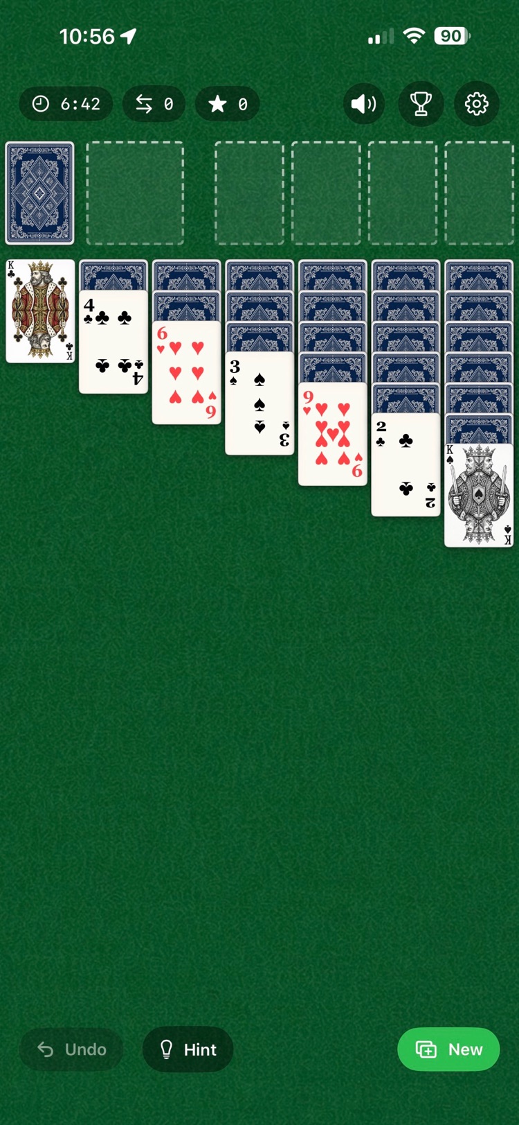 Classic Solitaire on iPhone: green felt table with stock, foundations, and seven tableau columns